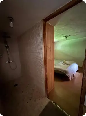 a room with a bedroom with a bed and a mirror at petit chalet in Chamonix-Mont-Blanc