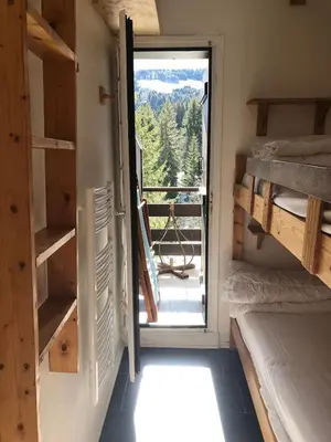 a room with a door open to a balcony with a view at Odyssée des Cimes in Saint-Gervais-les-Bains