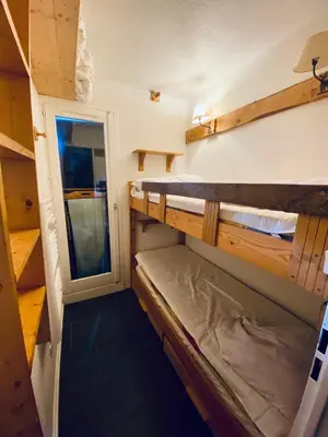 a small room with two bunk beds in it at Odyssée des Cimes in Saint-Gervais-les-Bains