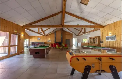 a room with billiard tables and a pool table at Sympathique appartement à Samoëns in Samoëns
