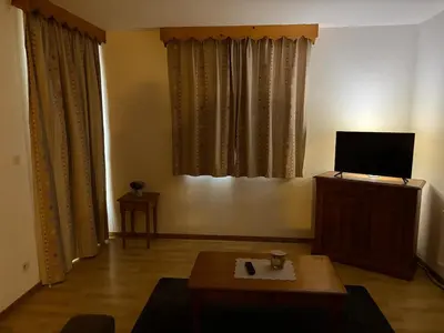 a living room with a tv and a coffee table at Sympathique appartement à Samoëns in Samoëns