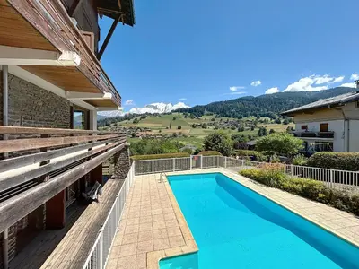 a swimming pool on the side of a house at Appartement 3 Pièces avec Parking et Vue Mont Blanc - FR-1-560-174 in Combloux