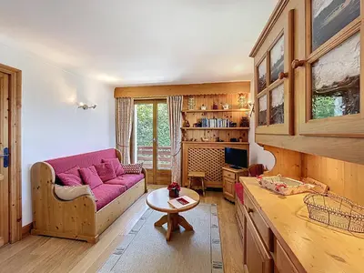 a living room with a pink couch and a table at Appartement 3 Pièces avec Parking et Vue Mont Blanc - FR-1-560-174 in Combloux