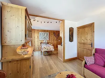 a living room with wooden walls and a purple couch at Appartement 3 Pièces avec Parking et Vue Mont Blanc - FR-1-560-174 in Combloux
