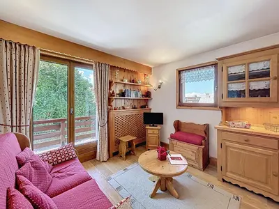 a living room with a purple couch and a table at Appartement 3 Pièces avec Parking et Vue Mont Blanc - FR-1-560-174 in Combloux