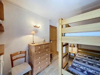 a bedroom with a bunk bed and a dresser and a desk at Appartement 3 Pièces avec Parking et Vue Mont Blanc - FR-1-560-174 in Combloux
