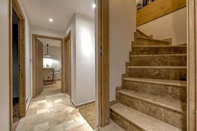 a hallway with stairs in a house at Beautiful new flat by the forest in Chamonix-Mont-Blanc