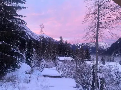a winter scene with snow and trees and mountains at Beautiful new flat by the forest in Chamonix-Mont-Blanc