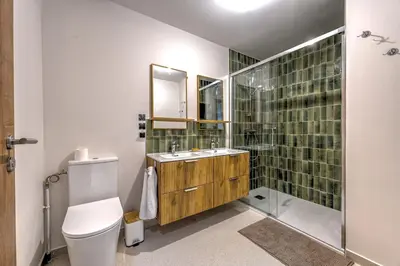 a bathroom with a toilet and a sink and a shower at Beautiful new flat by the forest in Chamonix-Mont-Blanc