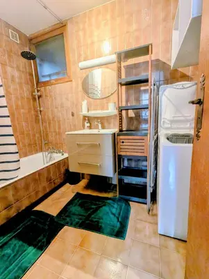 a bathroom with a sink and a tub and a refrigerator at Appartement 60m2 avec une vue exceptionnelle in Sallanches