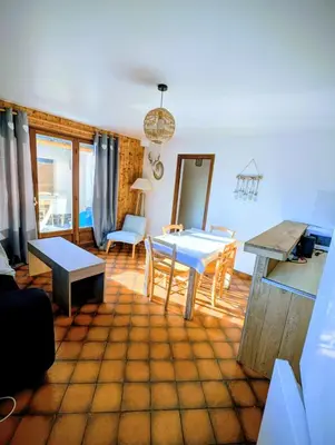 a living room with a table and a dining room at Appartement 60m2 avec une vue exceptionnelle in Sallanches