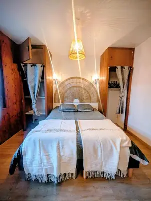 a bedroom with a bed and a chandelier at Appartement 60m2 avec une vue exceptionnelle in Sallanches