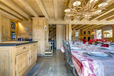 a dining room with a long table and a chandelier at Michka - Chalet 500m Flegere Cheminee Jardin Vue 180 in Chamonix-Mont-Blanc