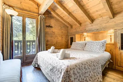 a bedroom with two beds in a log cabin at Michka - Chalet 500m Flegere Cheminee Jardin Vue 180 in Chamonix-Mont-Blanc