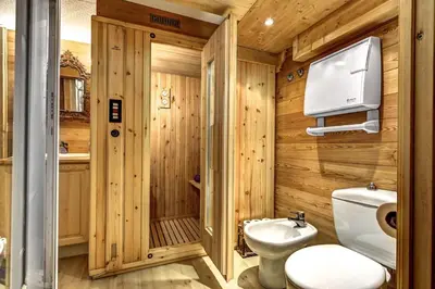 a wooden bathroom with a toilet and a sink at Passon - Appart 2CH 93m2 Sauna 300m Grand Montets Vue in Chamonix-Mont-Blanc