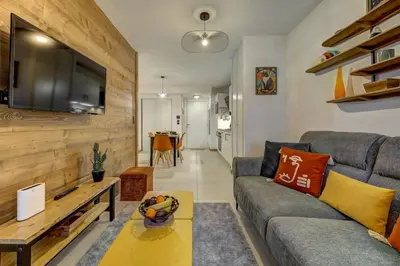 a kitchen and living room with a table and chairs at Kayla - Cosy 4pax Remontees 5mn Vue SPA Garage in Les Houches