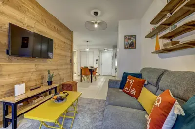 a living room with a couch and a table at Kayla - Cosy 4pax Remontees 5mn Vue SPA Garage in Les Houches