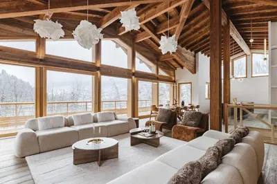 a living room with couches and tables and windows at 7 Summits - Chalet 230m2 Salon Cathedrale Vues Cheminee in Les Houches