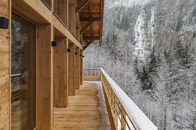 a stairway leading to a building with a snow covered mountain at 7 Summits - Chalet 230m2 Salon Cathedrale Vues Cheminee in Les Houches
