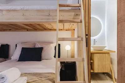 a room with a bunk bed and a bathroom at 7 Summits - Chalet 230m2 Salon Cathedrale Vues Cheminee in Les Houches