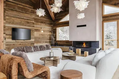 a living room with white furniture and a fireplace at 7 Summits - Chalet 230m2 Salon Cathedrale Vues Cheminee in Les Houches