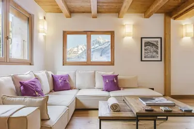 a living room with a white couch and purple pillows at Marmottes - Chalet 7CH Familial 200m2 Cheminee Calme Vue in Les Houches
