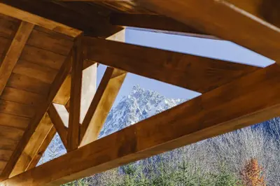 a view of a mountain through a window in a cabin at Marmottes - Chalet 7CH Familial 200m2 Cheminee Calme Vue in Les Houches
