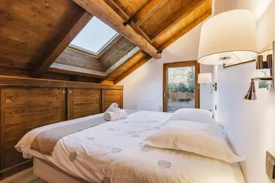 a bedroom with a large bed with wooden ceilings at Marmottes - Chalet 7CH Familial 200m2 Cheminee Calme Vue in Les Houches