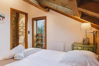 a bedroom with a white bed and a window at Marmottes - Chalet 7CH Familial 200m2 Cheminee Calme Vue in Les Houches