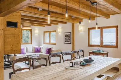 a living room with a table and a couch at Marmottes - Chalet 7CH Familial 200m2 Cheminee Calme Vue in Les Houches