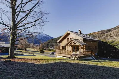 a log cabin in the mountains with a tree at Marmottes - Chalet 7CH Familial 200m2 Cheminee Calme Vue in Les Houches