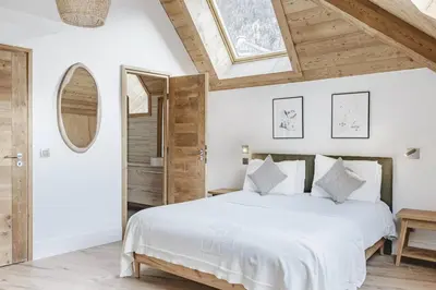 a bedroom with a white bed and a skylight at Ciel - Duplex 100m2 Centre Vues Parking 3CH 3SDB in Chamonix-Mont-Blanc