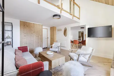 a living room with a couch and chairs and a tv at Ciel - Duplex 100m2 Centre Vues Parking 3CH 3SDB in Chamonix-Mont-Blanc