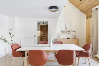 a dining room with a white table and chairs at Ciel - Duplex 100m2 Centre Vues Parking 3CH 3SDB in Chamonix-Mont-Blanc