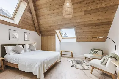 a bedroom with a large bed and wooden ceilings at Ciel - Duplex 100m2 Centre Vues Parking 3CH 3SDB in Chamonix-Mont-Blanc