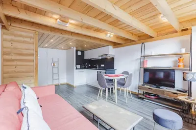 a living room with a couch and a table at Grand Roc - Cosy Duplex Grands Montets Balcon Vue Parking in Chamonix-Mont-Blanc