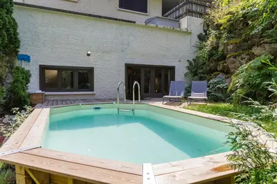 a swimming pool in front of a house at Loft Bellevue Remonte Centre Piscine Parking in Les Houches