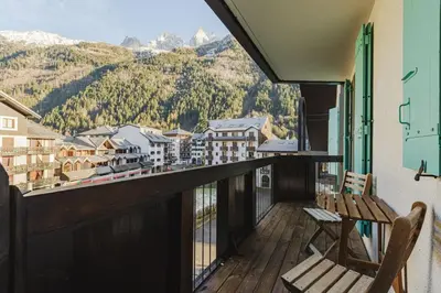 a balcony with a view of a town and mountains at Beckett - Cocon familial Central Balcon Vue 200m Gare in Chamonix-Mont-Blanc