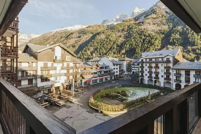 a view from a balcony of a town with mountains at Beckett - Cocon familial Central Balcon Vue 200m Gare in Chamonix-Mont-Blanc