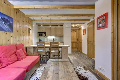 a living room with a couch and a kitchen at Aiguilles Rouges - Apart 4pax Vues Terrasse Calme 50m Super U in Les Houches