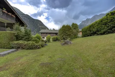a house on a hill next to a grass field at Aiguilles Rouges - Apart 4pax Vues Terrasse Calme 50m Super U in Les Houches