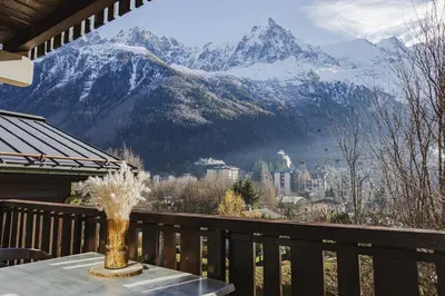 a table on a balcony with a view of a mountain at Pecles - Apt 2CH Balcon Vue Gaillands 500m Centre 1km in Chamonix-Mont-Blanc