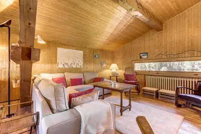 a living room with a couch and a table at Le 111 - Chalet 4CH Calme Vue Pano 5mn Grands Montets in Chamonix-Mont-Blanc