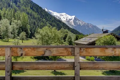 a wooden fence in front of a mountain at Le 111 - Chalet 4CH Calme Vue Pano 5mn Grands Montets in Chamonix-Mont-Blanc