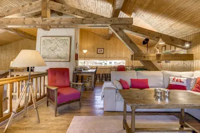 a living room with a couch and a table at Le 111 - Chalet 4CH Calme Vue Pano 5mn Grands Montets in Chamonix-Mont-Blanc