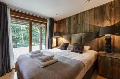 a bedroom with a large bed with towels on it at Whisky - Chalet 150m2 Calme Sauna Jacuzzi in Chamonix-Mont-Blanc
