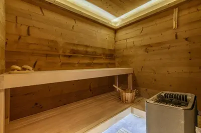 a wooden cabin with a shelf and a trash can at Whisky - Chalet 150m2 Calme Sauna Jacuzzi in Chamonix-Mont-Blanc