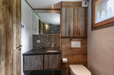 a bathroom with a sink and a toilet and a mirror at Whisky - Chalet 150m2 Calme Sauna Jacuzzi in Chamonix-Mont-Blanc