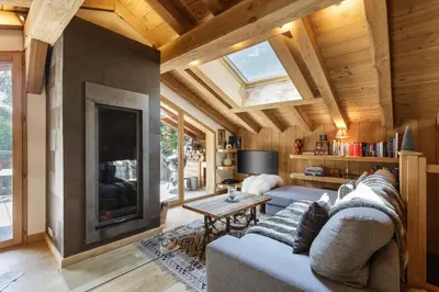 a living room with a couch and a fireplace at Whisky - Chalet 150m2 Calme Sauna Jacuzzi in Chamonix-Mont-Blanc