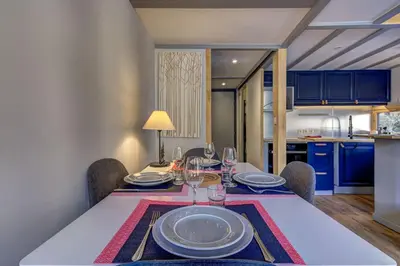 a dining room with a table with wine glasses at Fontanes - Duplex 200m Grands Montets Balcon Vue Parking in Chamonix-Mont-Blanc